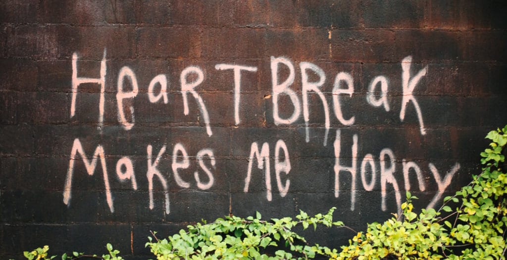 Graffiti on a wall about heartbreak